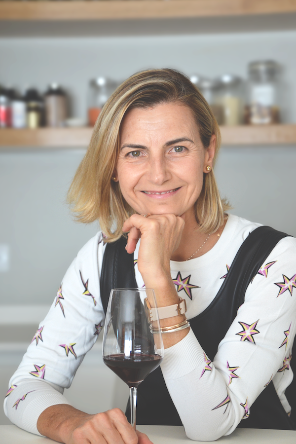 Woman holding glass of red wine and smiling