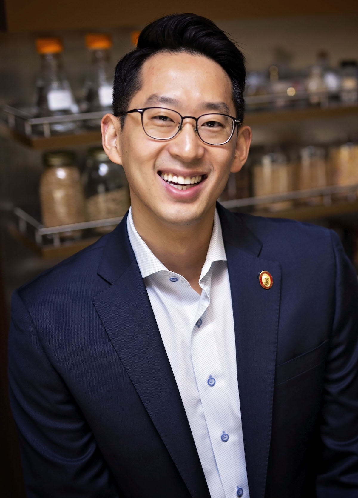 Man in suit looks at camera and smiles
