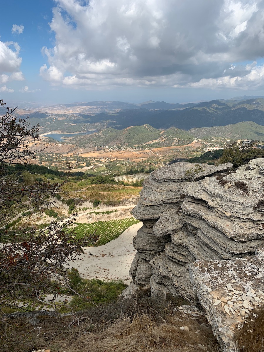 Rocky outcropping with vineyards spread below