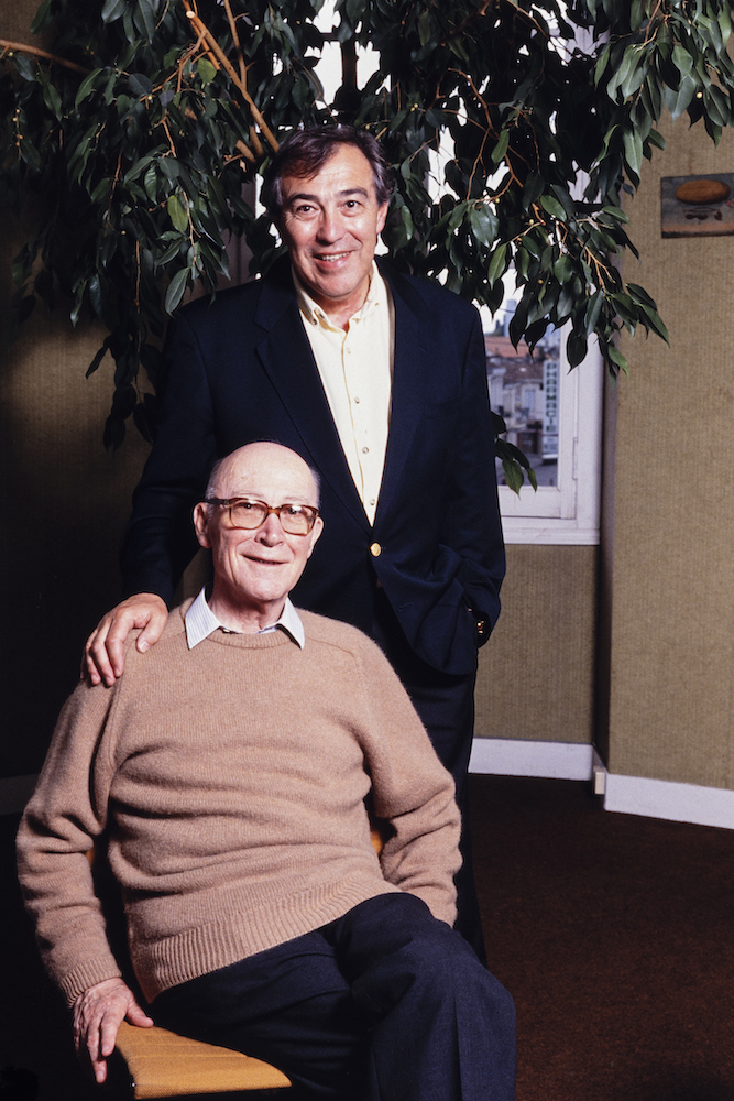 Middle-aged and older man pose together for camera