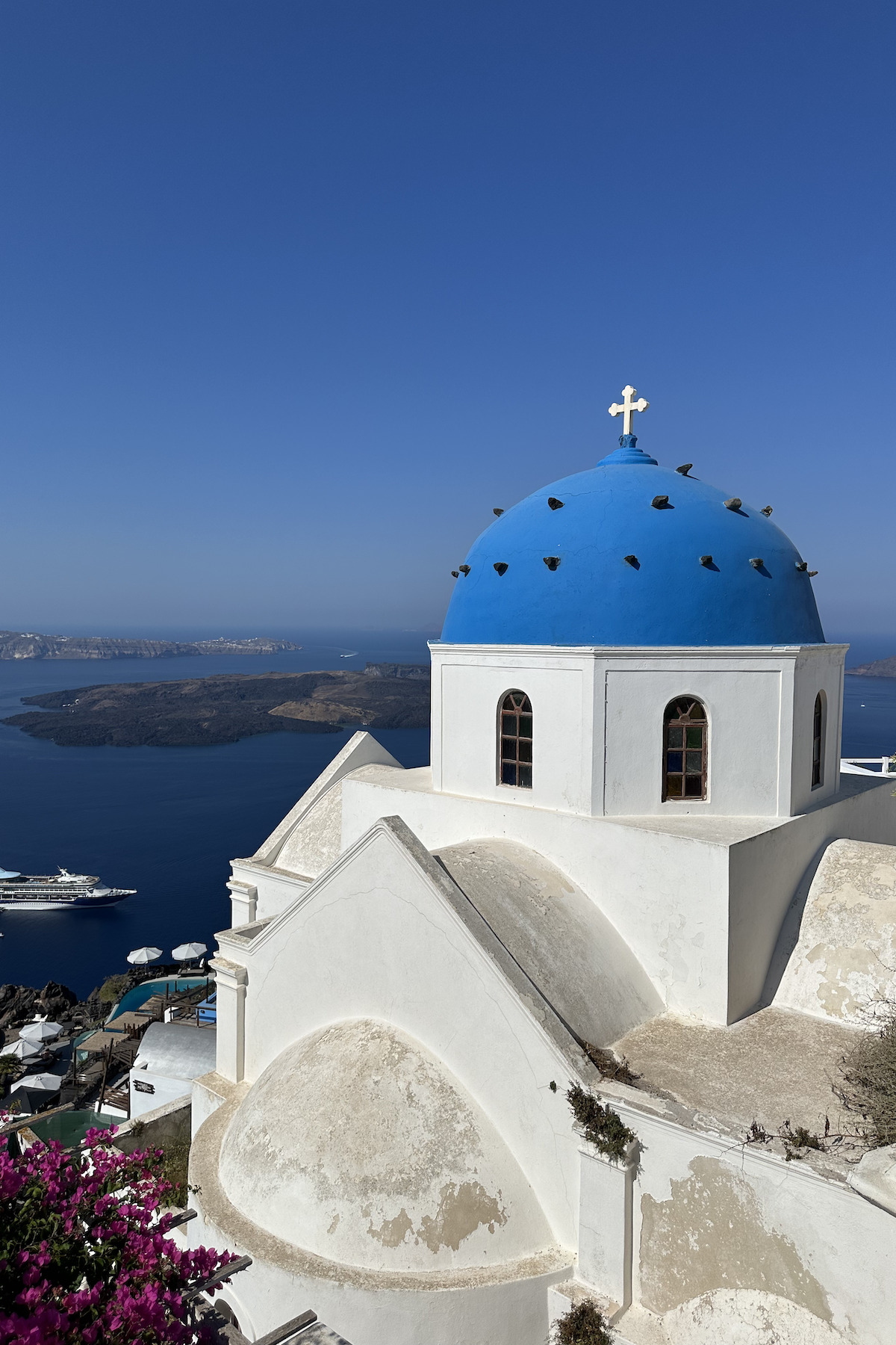 White building with blue cupola and blue sky behind