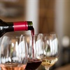 glasses of white, rosé, and red wine being filled