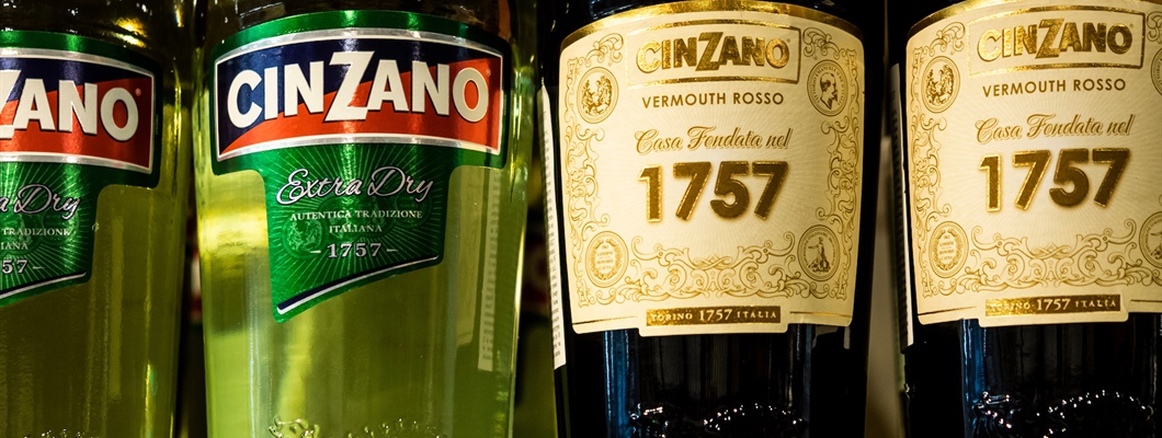Bottles of Cinzano Extra Dry and Rosso Vermouth on a shelf
