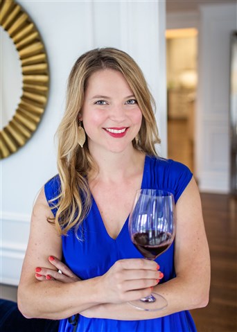 Amanda Barnes holding glass of red wine