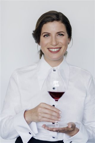 Paz Levinson holding glass of wine
