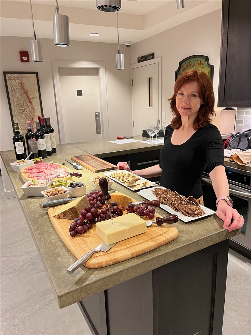 Woman in kitchen smiles at camera